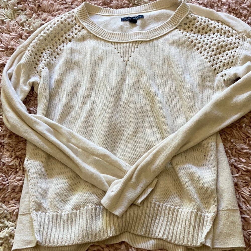 Cream coloured sweater,knitting on both shoulders